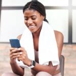 Black woman looking at CRS apps on her phone