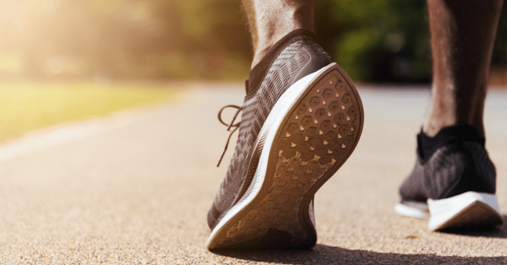 Close-up shot of a runner’s black and white shoes