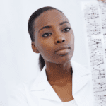 Black woman reading results from genetic testing