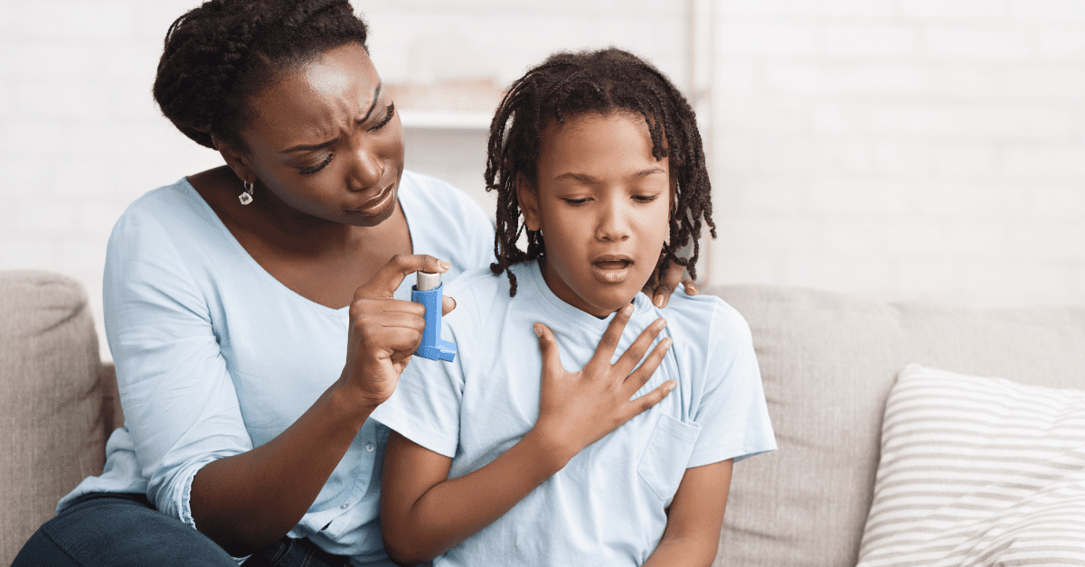 Black mom and son trying to use inhaler