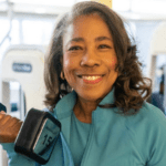 Community member, Ms. Gail, holding a gym weight