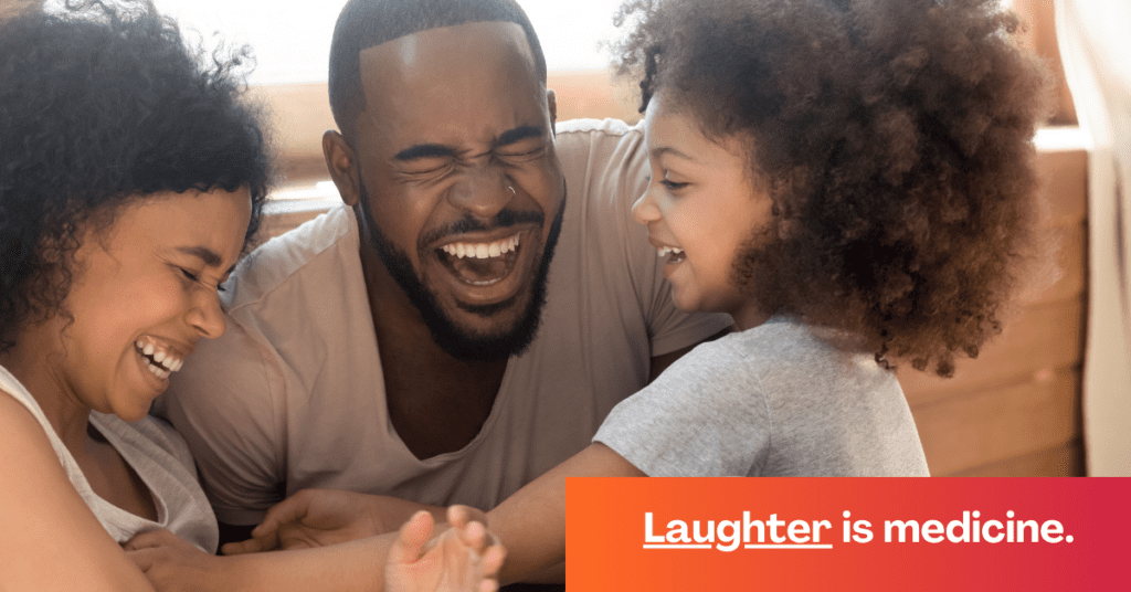 Black dad, mom, and daughter laughing