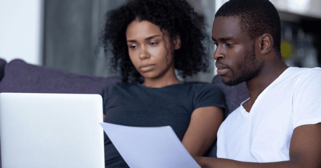 Black couple on their laptops likely job searching