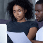 Black couple on their laptops likely job searching