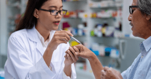 Elderly man getting his hand examined at the doctor’s office