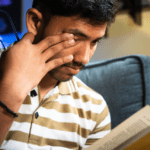 Is It Anxiety or a Rare Muscle Disorder? 5 Young boy reading book and pressing one eye with his fingers