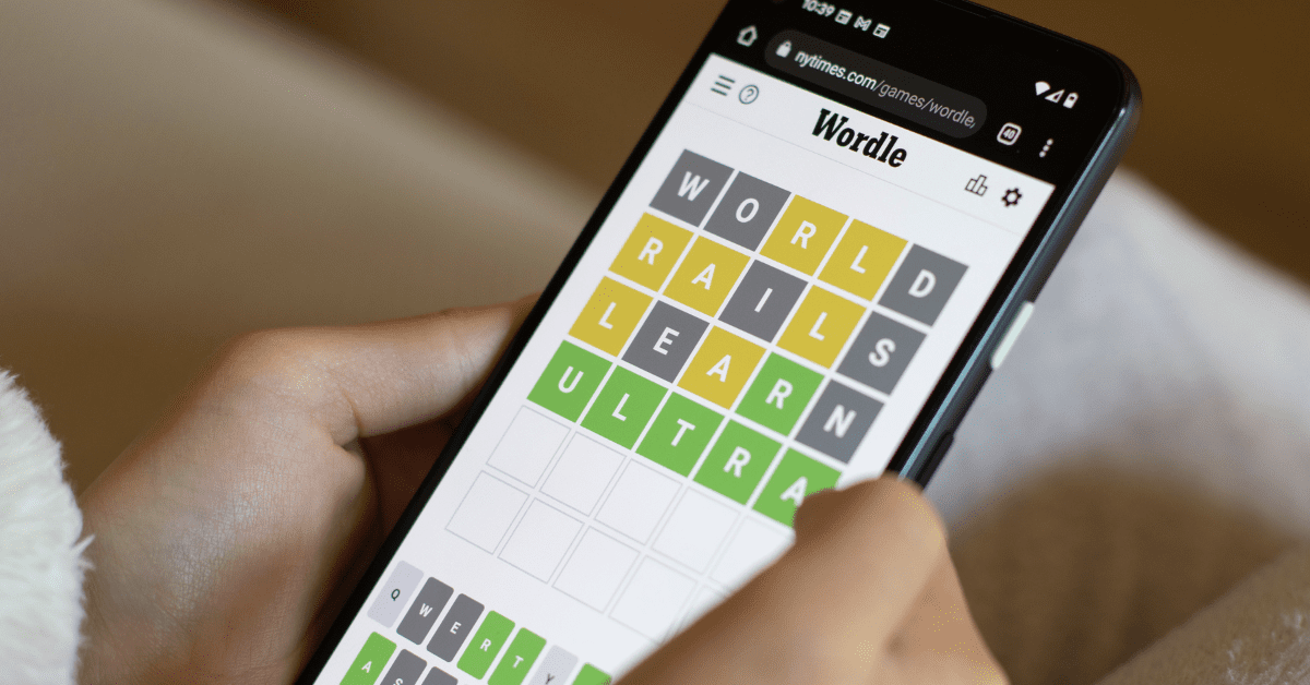 Close-up of a person playing Wordle on their phone