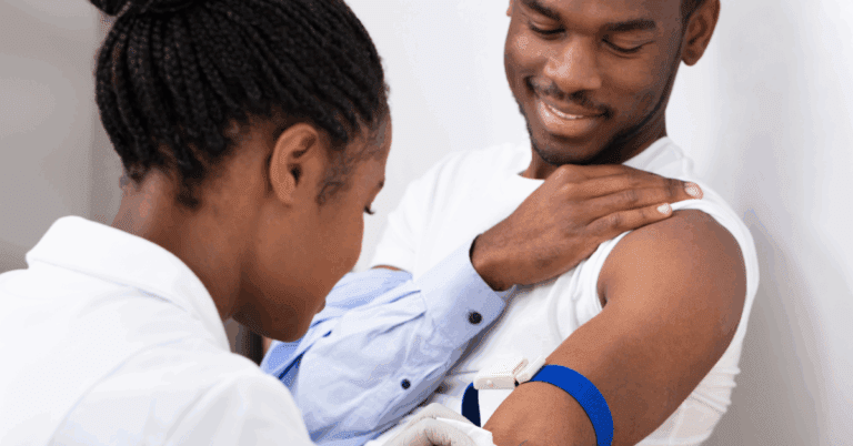 5 Websites To Help You Find the Right Therapist 1 Close-up Of female doctor injecting Black male patient with syringe to collect a blood sample