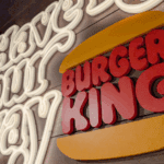 Neon sign that reads “Have it your way” next to the Burger King logo