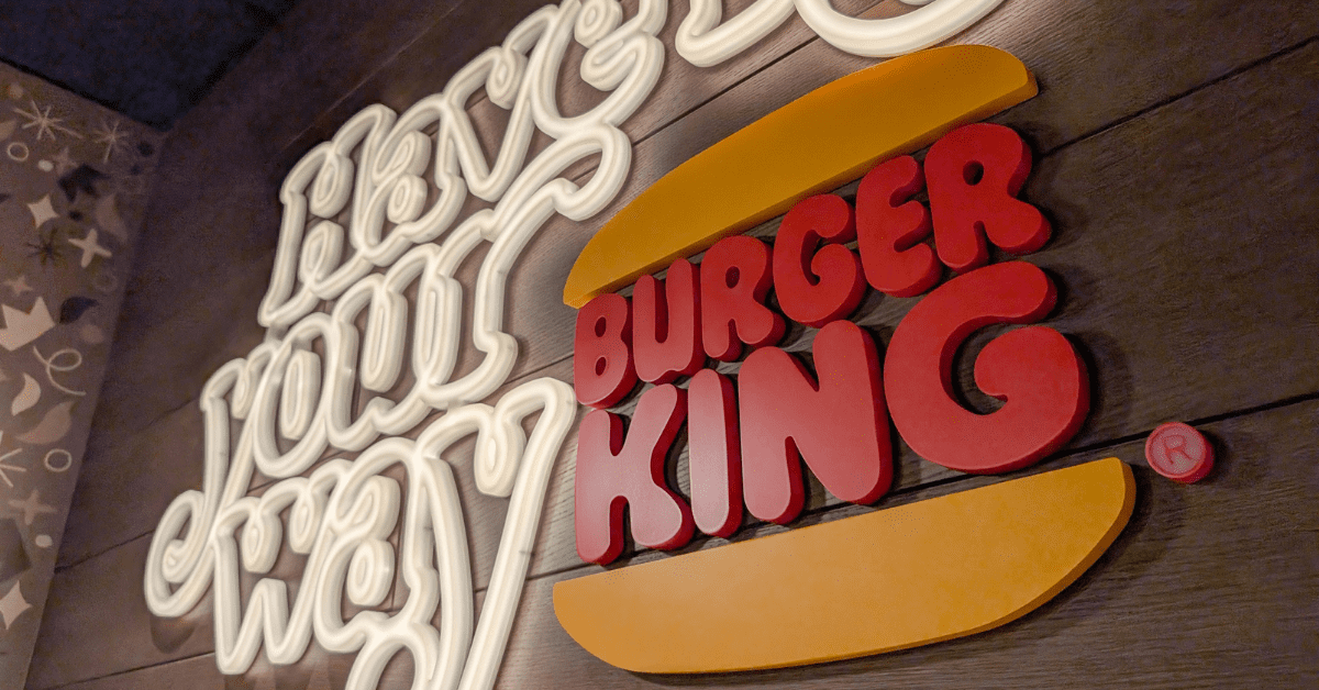 Neon sign that reads “Have it your way” next to the Burger King logo