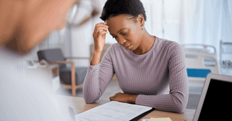 Meet NOWINCLUDED’s New Chatbot: NIA 1 Young Black woman stressed about medical bills in hospital
