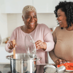 3 Magic Ingredients That May Help People With Heart Failure 5 Black family of three cooking a heart failure friendly meal. The mom is stirring the pot while her daughter and son cut vegetables, like carrots and zucchinis, on either side of her.