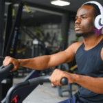 Young Black man using a peloton bike at the gym