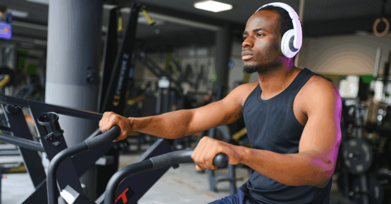What Happens to Your Blood Pressure After a Workout? 1 Young Black man using a peloton bike at the gym