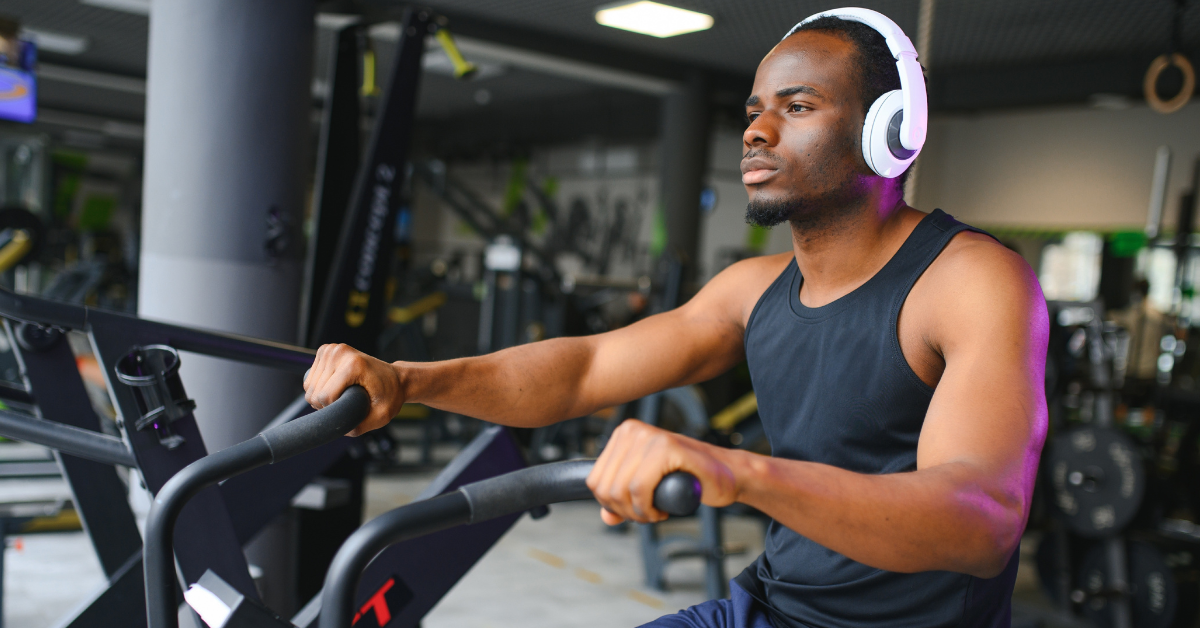 Young Black man using a peloton bike at the gym