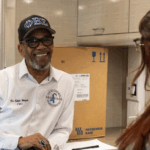 Dr. Edward Wright, founder of The We Can Win Foundation, in a fraternity baseball cap, smiling at a person off-camera