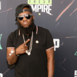 Philadelphia rapper and kidney disease survivor, Freeway, standing in front of a step and repeat banner