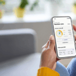 Close-up of someone holding Lumen, a gut health device, and tracking the results on their phone