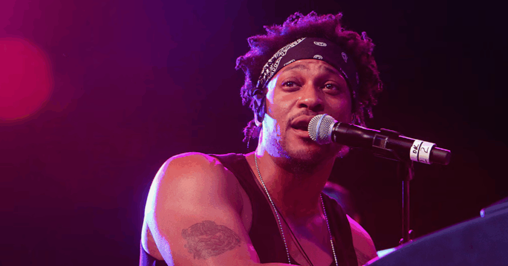 General Wellness 12 Neo-soul singer, D’Angelo, singing into a mic on stage before his passing from pancreatic cancer