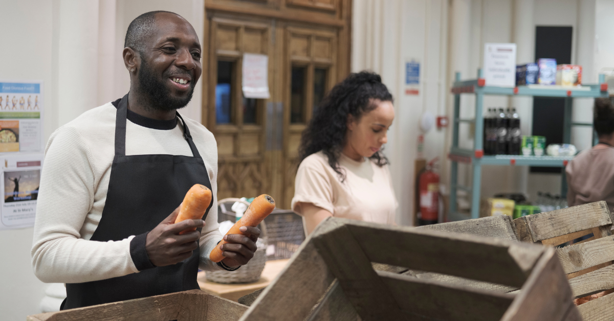 Smiling volunteers helping at a food bank during the loss of SNAP benefits