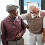 Happy diverse group of senior men laughing with their hands around each other. They are over the age of 40 indicating that they should care for their prostate health.