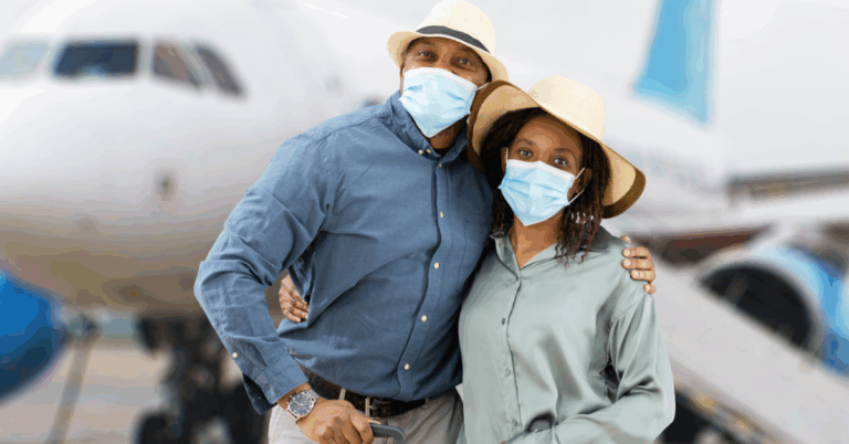 Young African American couple wearing masks and beach hats, standing in front of a plane, ready to travel