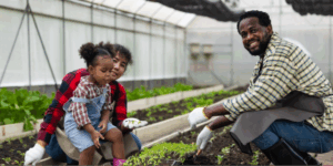 A multiracial family engaging in affordable gardening practices to reduce environmental toxins.