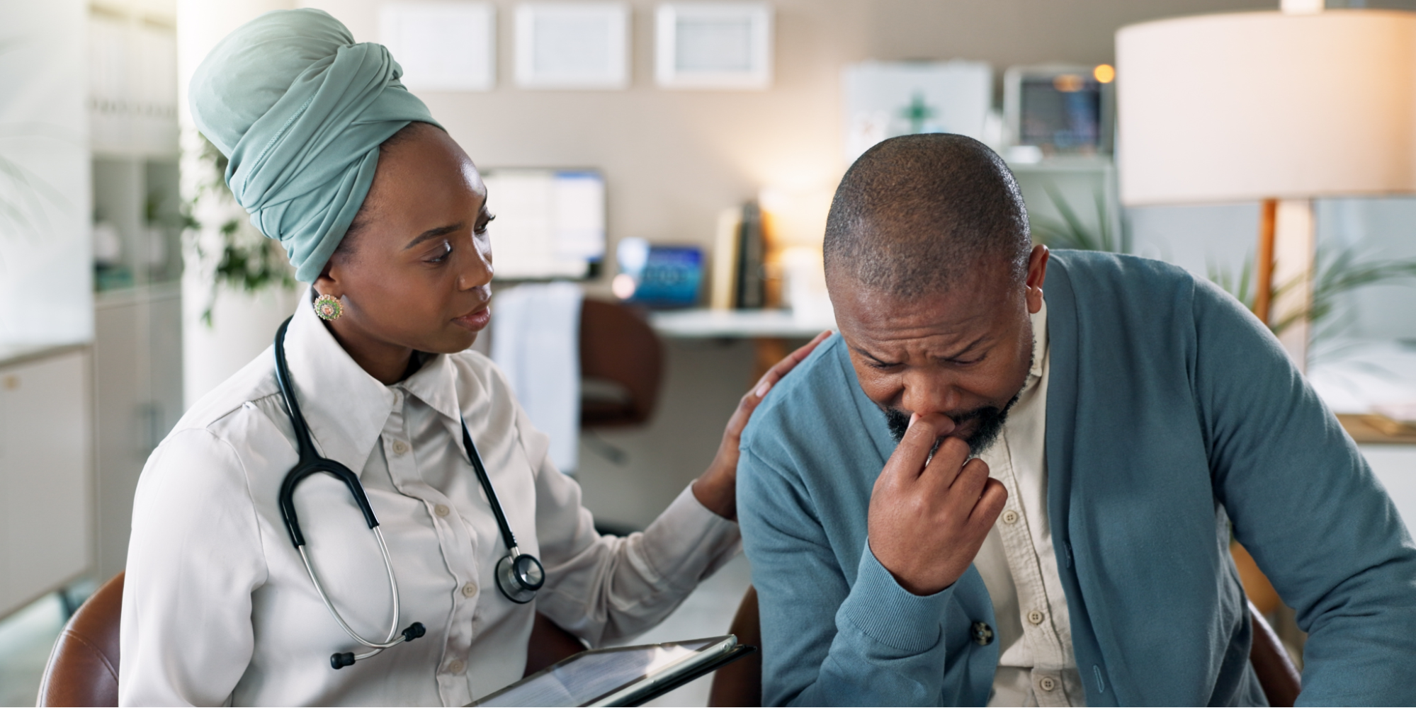 A Black man looking concerned while receiving news about needing prostate cancer surgery from a healthcare provider.