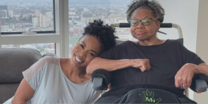 Actress and caregiver, Brandee Evans, smiling while leaning her head on her mother, Diana Harrington, who lives with multiple sclerosis and early-onset Alzheimer's.