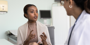 A young woman requesting a full hormone panel from her doctor in an exam room.
