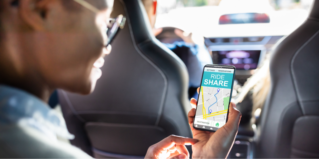 Close-up of a Black woman&rsquo;s hand holding a phone with a ride share GPS, getting free transportation to her radiation appointment.