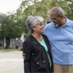 Older Black couple taking a walk outside, one of the ways dementia can be prevented